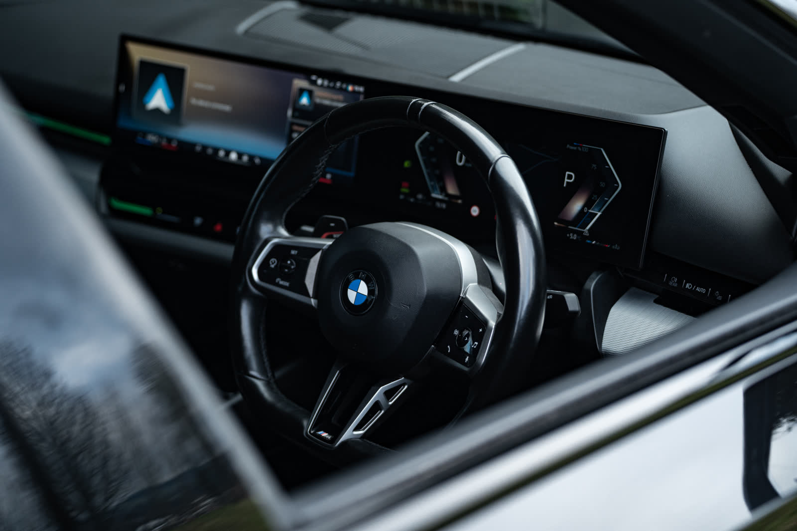 BMW 5 Series M Sport interior, steering wheel and curved display